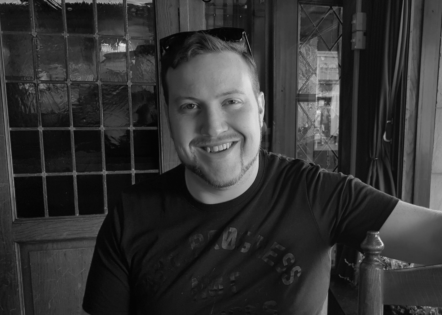 Jarryd, smiling at a table